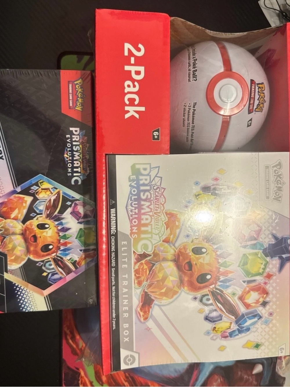 PRISMATIC EVOLUTIONS ETB+POKE BALL AND SURPRISE BOX.